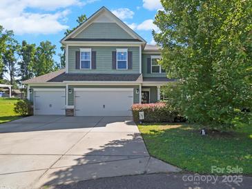 Charming two-story home with a three car garage and beautiful landscaping at 159 Autumn Mist Rd, Statesville, NC 28677