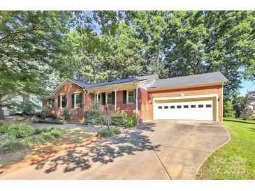 Charming brick home with a two-car garage and a well-maintained front yard at 16509 Kimbolten Dr, Huntersville, NC 28078
