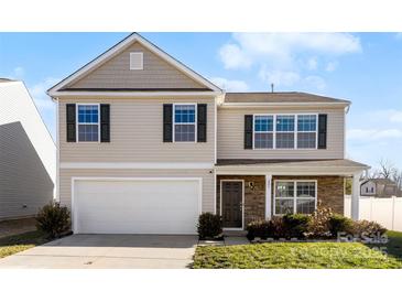Charming two-story home with attached garage, stone accents, and well-maintained lawn at 221 Brenett Francis Ct, Charlotte, NC 28214