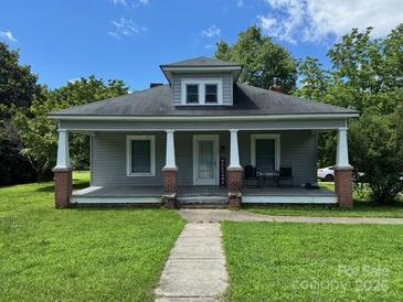 Charming single-story home featuring a covered porch with columns and well-maintained landscaping at 2417 Statesville Blvd, Salisbury, NC 28147