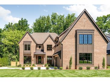 Stunning brick home with manicured lawn, professionally landscaped, and traditional architectural details at 412 Jefferson Dr, Charlotte, NC 28270