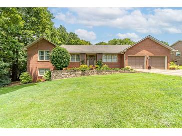 Charming single-story brick home with a well-manicured lawn and a two-car attached garage at 7029 Forest Hills Dr # 38, Denver, NC 28037