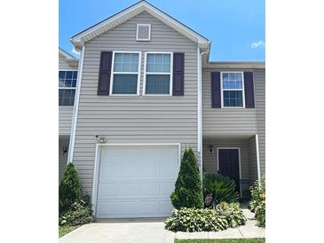 Inviting two-story home with a one-car garage and well-manicured landscaping at 9608 Brackenview Ct, Charlotte, NC 28214