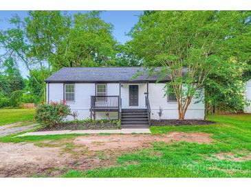 Charming single-story home with freshly painted exterior, landscaping, and inviting front porch at 1224 E Woodlawn Rd, Charlotte, NC 28209