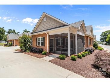 Charming brick home with a screened-in porch and beautifully landscaped yard at 2484 Early Richmond Ct, Denver, NC 28037