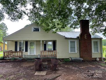 Front exterior view of house with chimney and wooden porch at 30497 Orchard Ln, Albemarle, NC 28001