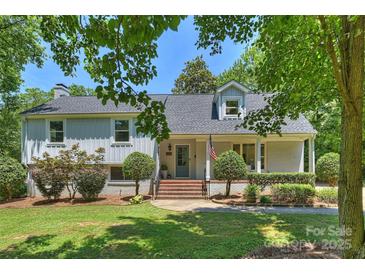 Charming two-story home with a brick and siding exterior, manicured lawn, and mature trees, creating a welcoming curb appeal at 3165 Pendleton Ave, Charlotte, NC 28210