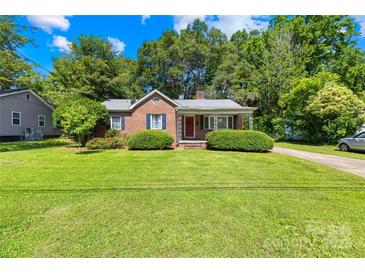 Charming brick home with a well-manicured front lawn and covered porch, creating a welcoming curb appeal at 506 Gold St, Shelby, NC 28150
