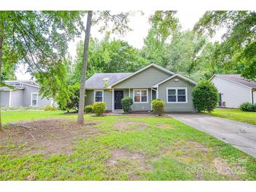Charming single-story home with a well-maintained lawn, inviting entrance, and mature trees at 5424 Amado St, Charlotte, NC 28215