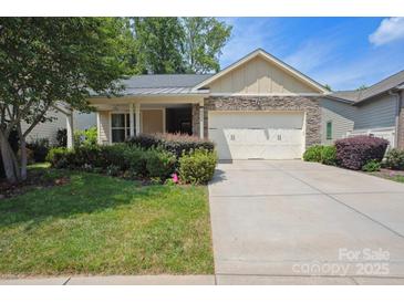 Charming home featuring a stone facade, manicured lawn, and a convenient two-car garage at 5524 Elk Knob Ct, Denver, NC 28037