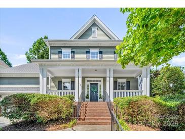 Charming two-story home with a welcoming front porch and well-manicured landscaping at 5728 Mantario Dr, Charlotte, NC 28269