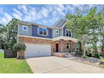 Charming two-story home featuring a stone facade, a front porch, and a two-car garage at 10304 Ebbets Rd, Charlotte, NC 28273