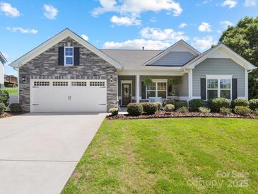Charming single-story home with stone accents, a two-car garage, and beautifully landscaped front yard at 117 Autumn Mist Rd, Statesville, NC 28677
