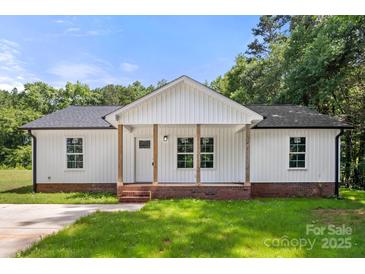 Charming single-story home with a welcoming front porch and well-maintained lawn at 1234 Goodnight Ln, Kannapolis, NC 28081