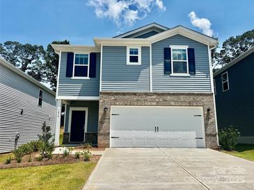 Charming two-story home with blue siding, brick accents, and a two-car garage at 1434 31St Ne St, Conover, NC 28613