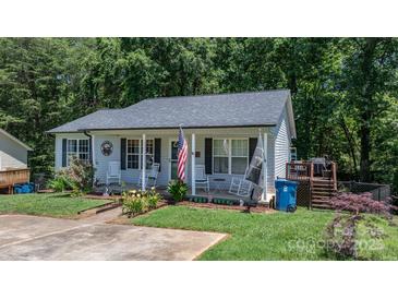 Charming single-story home with a welcoming front porch, lovely landscaping, and a gray roof at 431 Forest Dr, Maiden, NC 28650