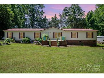 Charming single-story home with a well-manicured lawn and inviting front porch at 495 Brumley Rd, Mooresville, NC 28115