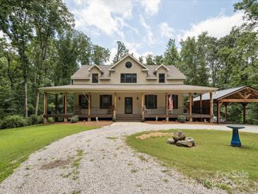 Inviting home showcasing a long covered porch and an oversized driveway at 820 King Rd, Clover, SC 29710