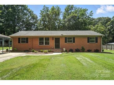 Charming brick home with a well-manicured lawn and mature trees, offering great curb appeal at 2705 Lowell Bethesda Rd, Gastonia, NC 28056