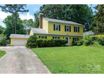 Charming two-story yellow home with a well-maintained front yard and classic black shutters at 2825 Edwin Jones Dr, Charlotte, NC 28269