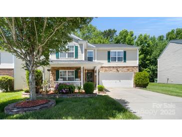 Charming two-story home featuring stone accents, green shutters, well-maintained landscaping, and a two-car garage at 3109 Buckleigh Dr, Charlotte, NC 28215