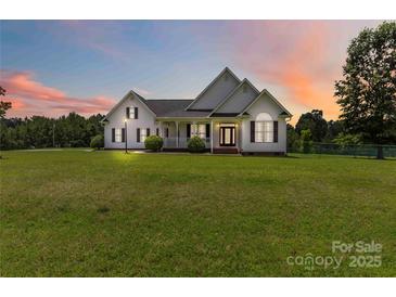 Charming single-Gathering home with a well-manicured lawn and inviting front porch at sunset at 3624 Ramsey Rd, Sharon, SC 29742
