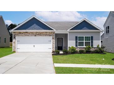 Charming single-story home featuring stone accents, a two-car garage, and well-maintained landscaping at 7106 Jerimoth Dr, Charlotte, NC 28215