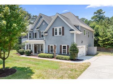 Charming two-story home with gray siding, brown shutters, and a well-manicured front yard at 738 Kemp Rd, Mooresville, NC 28117