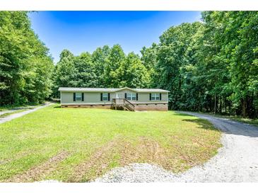 Charming single-story home with a covered front porch and a well-maintained lawn surrounded by mature trees at 812 Acclaim Dr, York, SC 29745