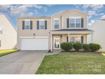 Two-story home with neutral siding, black shutters, a well-manicured lawn, and an attached two-car garage at 9822 Bayview Pkwy, Charlotte, NC 28216