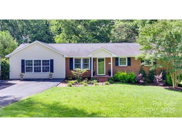 Charming single-story home features a well-manicured lawn and a mix of brick and siding exterior at 1498 Legion Rd, Fort Mill, SC 29715