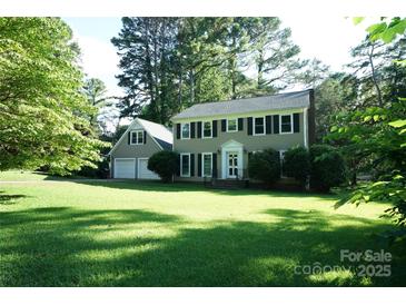 Charming two-story home with a well-manicured lawn and lush trees creating a picturesque setting at 2087 Poinsett Dr, Rock Hill, SC 29732