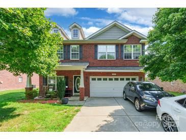 Charming two-story brick home featuring a well-manicured lawn and an attached two-car garage at 2476 Glyncastle Way, Gastonia, NC 28056