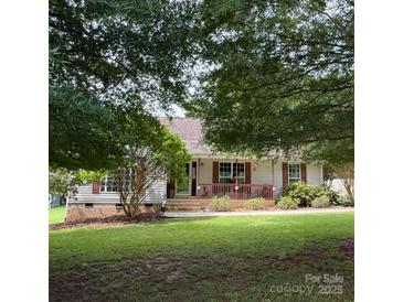 Charming single-story home featuring a welcoming front porch and lush green lawn at 2511 Old Pond Dr, Lincolnton, NC 28092