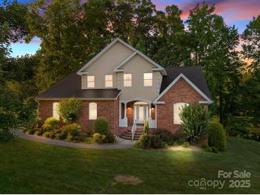 Charming two-story home with brick and stucco, manicured landscaping, and mature trees in a desirable neighborhood at 322 Oakview Dr, Salisbury, NC 28146