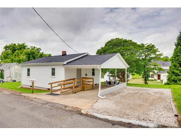 Charming single-story home with white siding, a covered parking area, and a handicap accessible ramp at 814 Grace St, Kings Mountain, NC 28086
