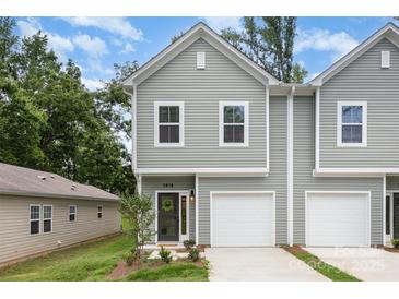 Charming townhome with neutral siding, well-manicured lawn, and attached garage at 2818 Old Steele Creek Rd, Charlotte, NC 28208