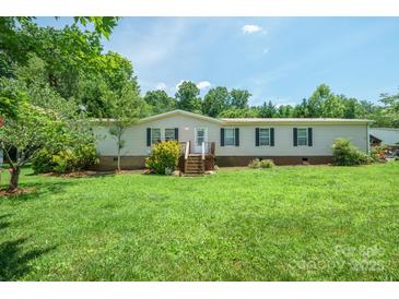 Traditional home featuring mature trees, an inviting porch, and a well-maintained lawn at 1495 Leonards Fork Church Rd, Lincolnton, NC 28092