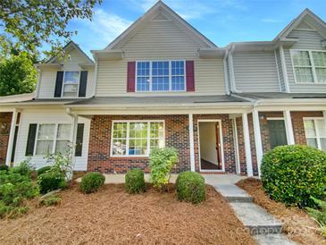 Charming townhouse with brick and siding facade, complemented by a well-manicured lawn at 5163 Ficus Tree Ln, Charlotte, NC 28215