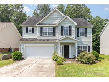 Charming two-story home featuring an attached garage, manicured lawn, and a welcoming entrance at 5233 Halverson Ct, Kannapolis, NC 28083