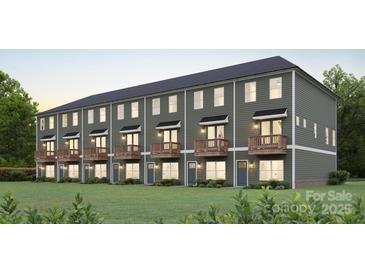 View of multiple modern townhomes with small wooden porches and green siding at 720 Drakeford Ct, Charlotte, NC 28216