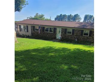 Charming brick home with a large, well-maintained front yard and inviting curb appeal at 111 Redwood Ln, Gastonia, NC 28052