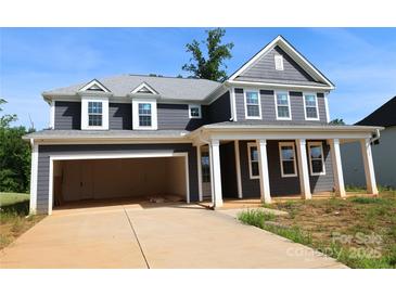 New two-story home with a two car garage and a covered front porch with classic white columns at 118 Still Creek Dr, Mooresville, NC 28115
