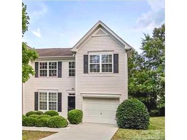 Charming two-story home featuring a front-entry garage, well-maintained landscaping, and classic architectural details at 2150 Winthrop Chase Dr, Charlotte, NC 28212
