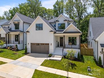 Beautiful two-story home with white siding, black trim, and a two-car garage at 3945 Plainview Rd, Charlotte, NC 28208