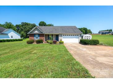 Charming single-story home with a well-maintained lawn, landscaping, and two-car garage at 402 Beaver Dam Church Rd, Shelby, NC 28152