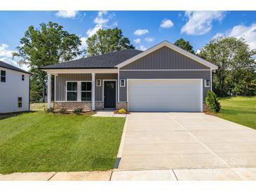 Charming single-story home featuring a two-car garage and a well-manicured front yard at 455 Contentment Ct # 18, Kannapolis, NC 28081