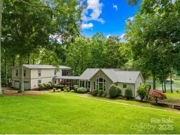 Charming lakeside home with lush lawn, mature trees, and attached guest house at 698 Normandy Rd, Mooresville, NC 28117
