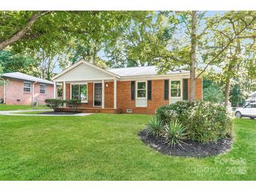 Charming brick home featuring a well-maintained lawn and mature trees at 835 Carrington Dr, Charlotte, NC 28214