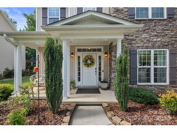 Inviting front door with a decorative wreath and charming landscaping at 137 Branchview Dr, Mooresville, NC 28115